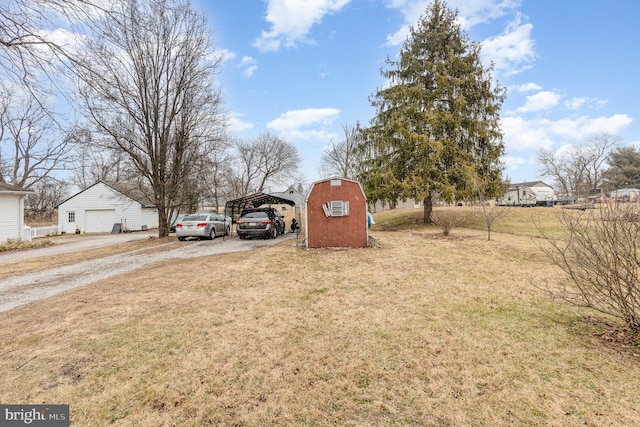 view of yard with a carport and a storage unit