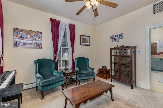 living area featuring ceiling fan, light carpet, and a baseboard heating unit