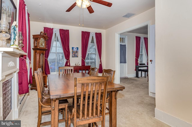 carpeted dining area featuring ceiling fan