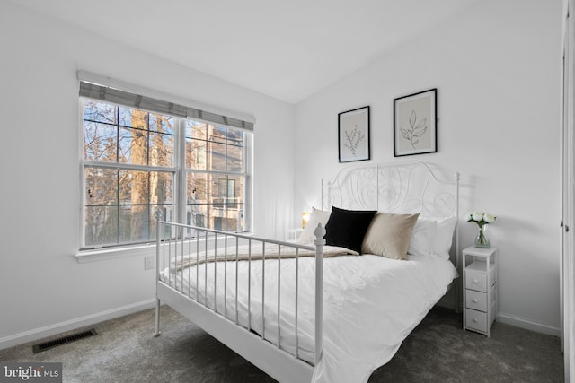 bedroom with baseboards, visible vents, and carpet floors