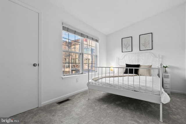 carpeted bedroom with visible vents, baseboards, and vaulted ceiling