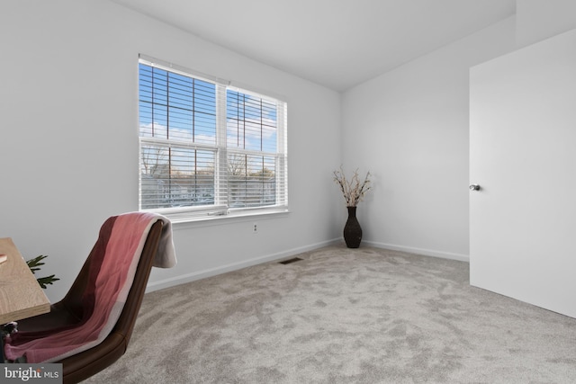 carpeted office with visible vents and baseboards