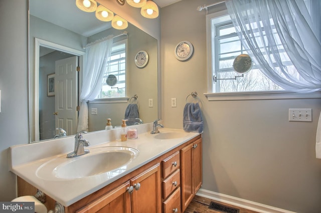 bathroom featuring visible vents, a wealth of natural light, and a sink
