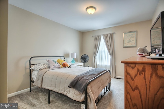 carpeted bedroom with baseboards and visible vents