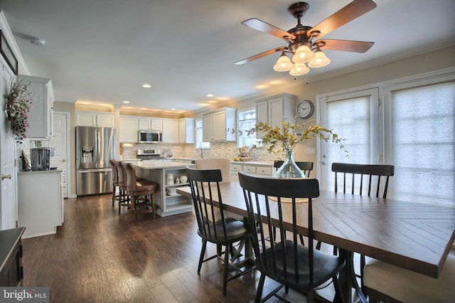 dining space featuring crown molding, ceiling fan, recessed lighting, and dark wood finished floors