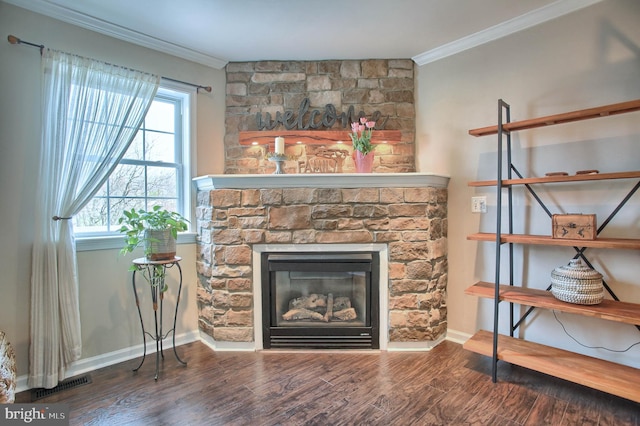 living room with a stone fireplace, visible vents, wood finished floors, baseboards, and ornamental molding