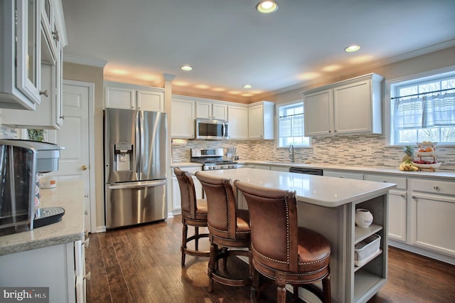 kitchen featuring crown molding, stainless steel appliances, open shelves, and backsplash