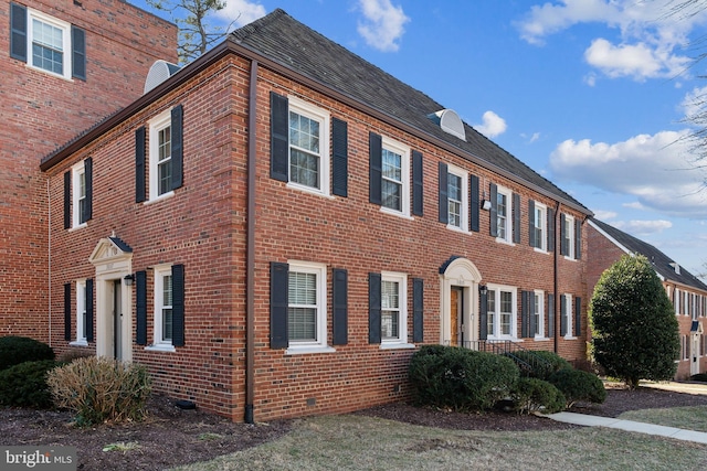 view of side of home with brick siding