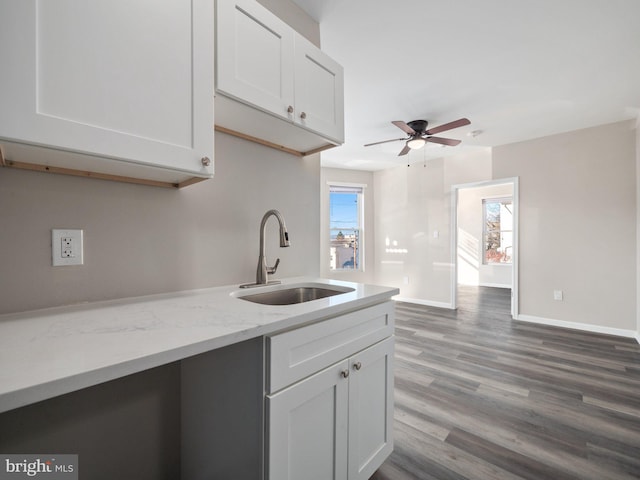 kitchen featuring white cabinetry, sink, hardwood / wood-style floors, and a healthy amount of sunlight