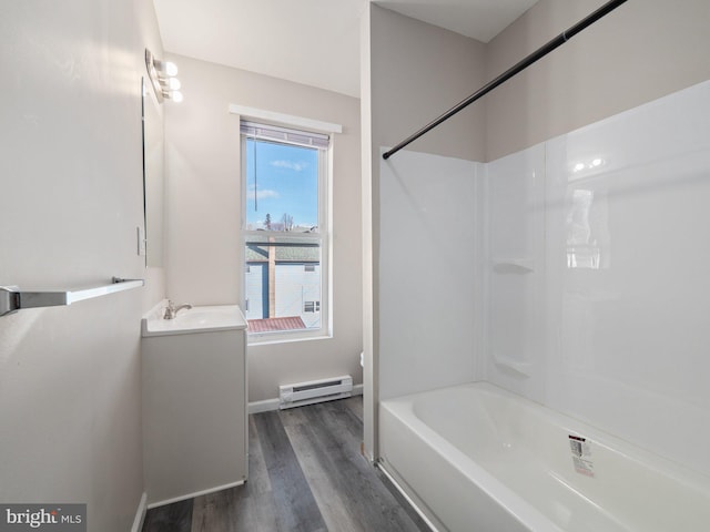 bathroom with vanity, hardwood / wood-style floors, shower / bath combination, and baseboard heating