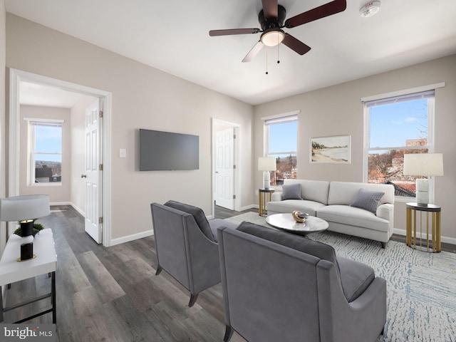 living room featuring dark hardwood / wood-style floors and ceiling fan