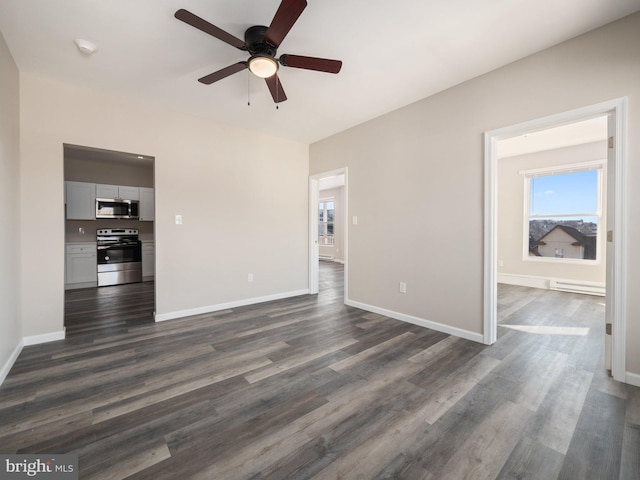 unfurnished living room with ceiling fan and dark hardwood / wood-style floors