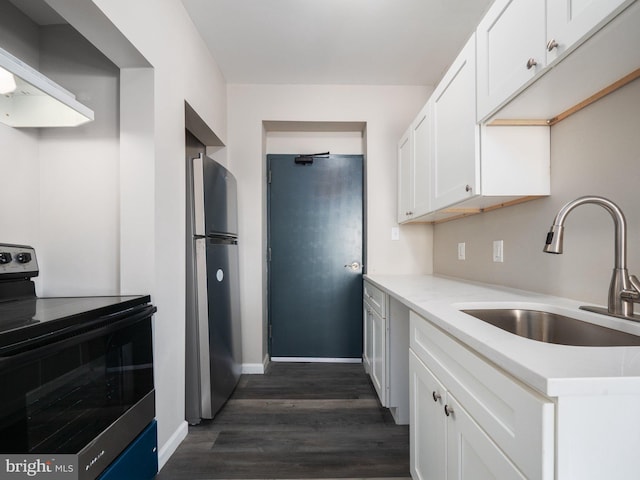 kitchen with sink, stainless steel appliances, dark hardwood / wood-style floors, white cabinets, and wall chimney exhaust hood