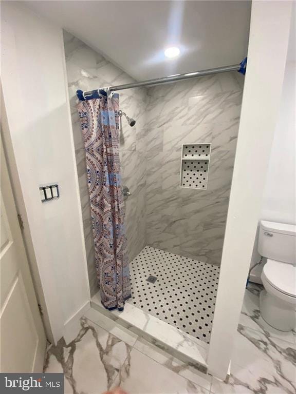 bathroom featuring toilet and walk in shower