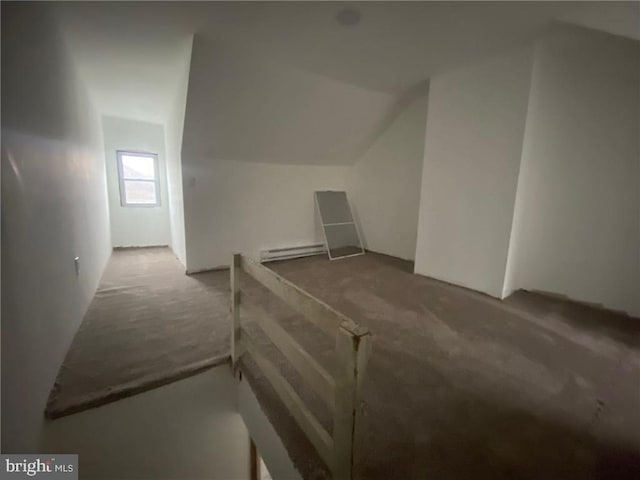 additional living space featuring baseboard heating and vaulted ceiling