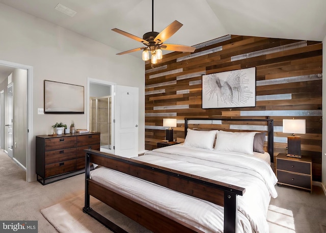 bedroom with light carpet, vaulted ceiling, and wood walls