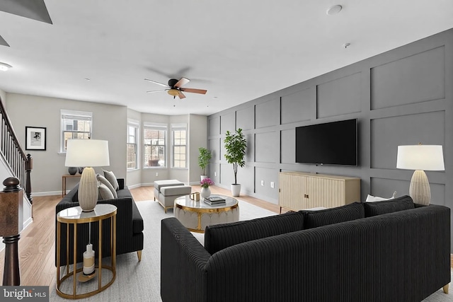 living room with ceiling fan and light hardwood / wood-style floors