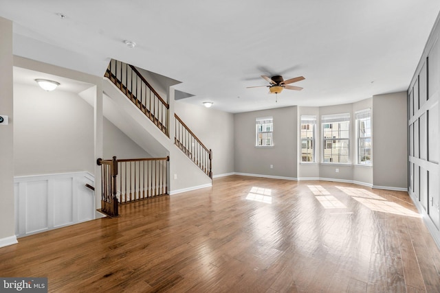 unfurnished living room featuring hardwood / wood-style floors and ceiling fan