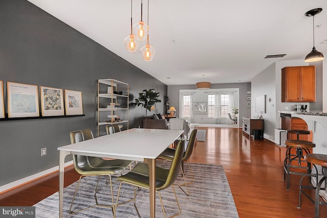 dining area featuring dark hardwood / wood-style floors