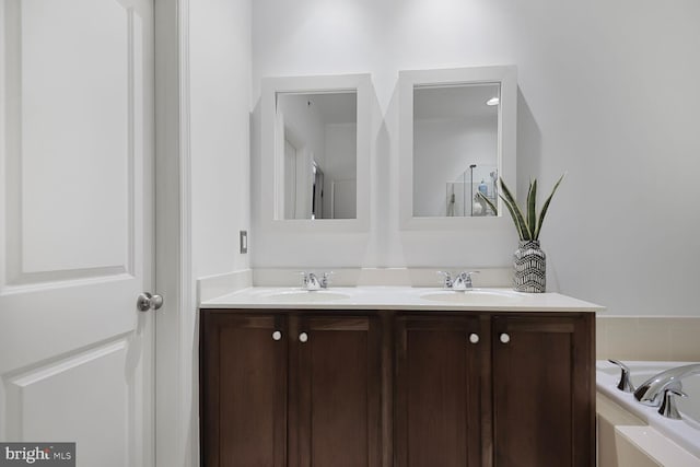 bathroom with vanity and a bath