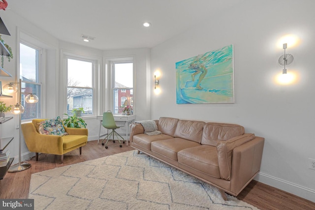 living room featuring recessed lighting, visible vents, baseboards, and wood finished floors