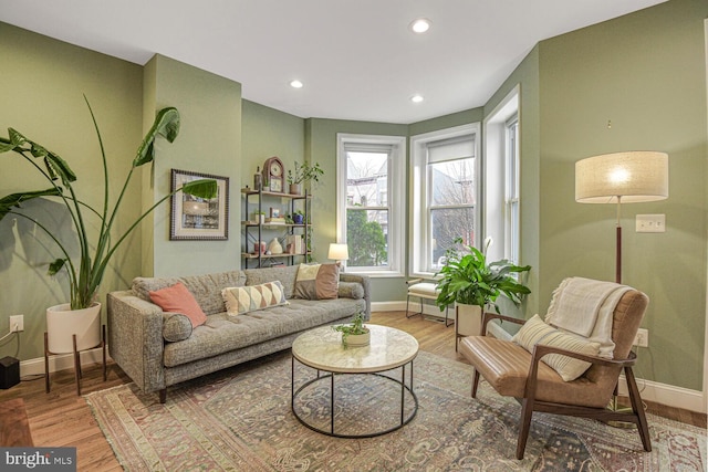 living area with recessed lighting, baseboards, and wood finished floors