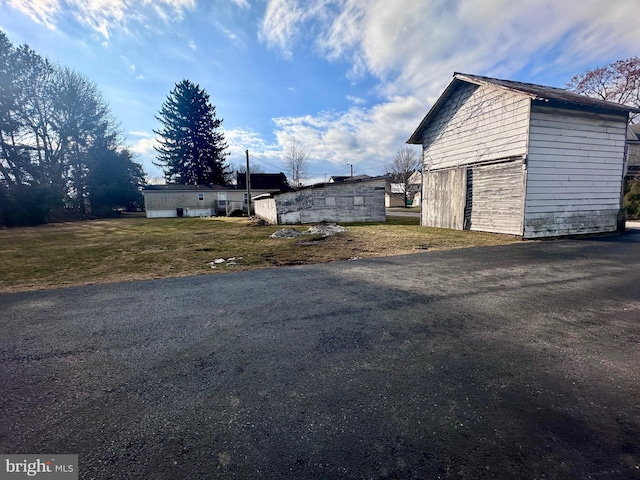 exterior space with a yard and an outbuilding