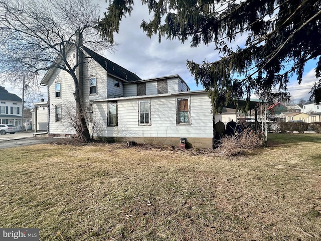 view of property exterior featuring a lawn