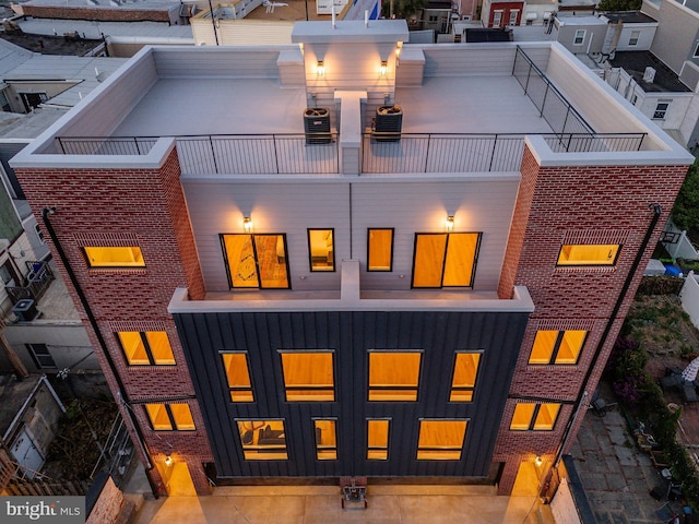 rear view of property featuring a balcony