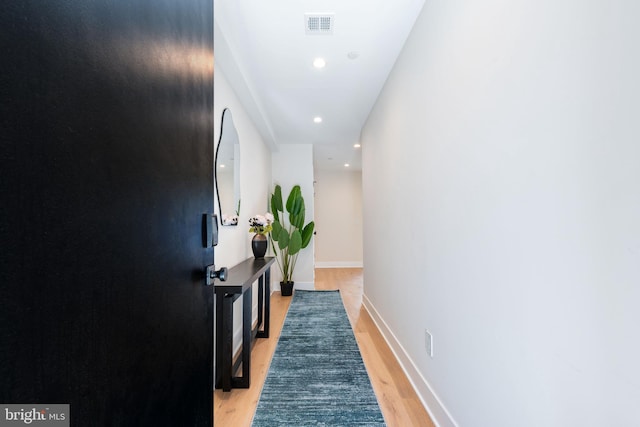 corridor with light wood-type flooring