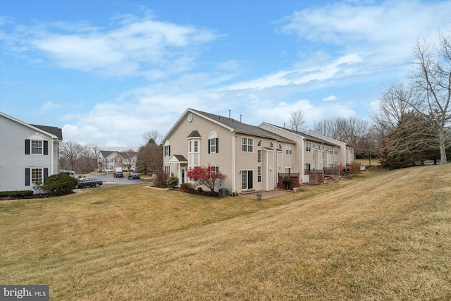 view of side of home with a lawn