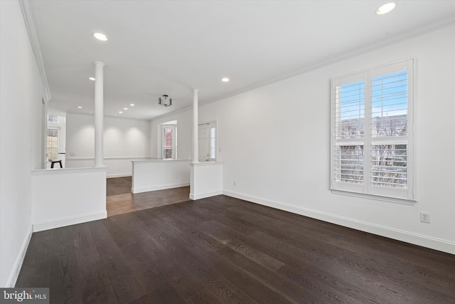 unfurnished living room featuring dark wood-type flooring, recessed lighting, decorative columns, and baseboards