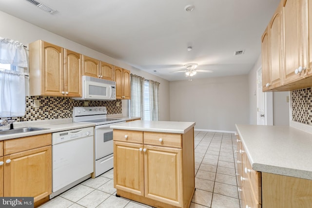 kitchen featuring sink, white appliances, a center island, light brown cabinetry, and decorative backsplash