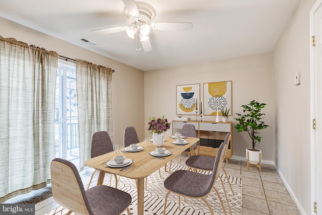 dining space with light tile patterned floors and ceiling fan