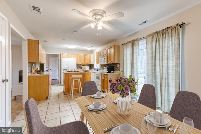 tiled dining room with ceiling fan