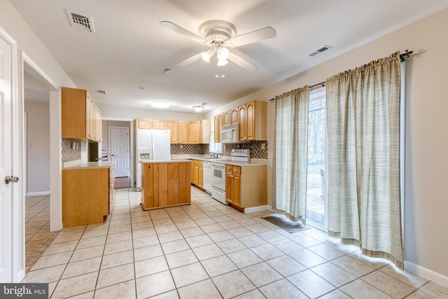 kitchen with a center island, light tile patterned floors, backsplash, and white appliances