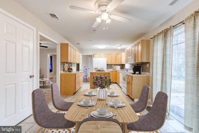 dining room with light tile patterned floors and ceiling fan