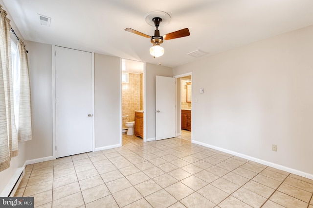 unfurnished bedroom featuring light tile patterned flooring and connected bathroom