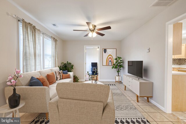 living room with light tile patterned floors and ceiling fan