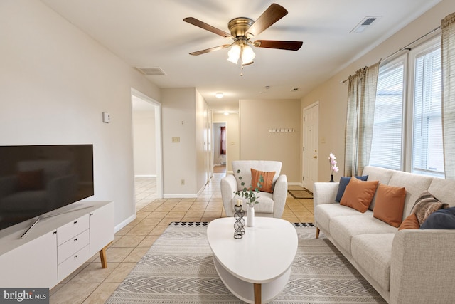 living room with light tile patterned flooring and ceiling fan