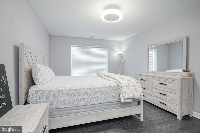 bedroom with dark wood finished floors