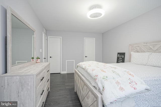 bedroom with dark wood finished floors