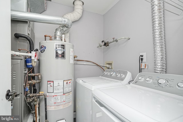 laundry area featuring laundry area, washing machine and dryer, and water heater