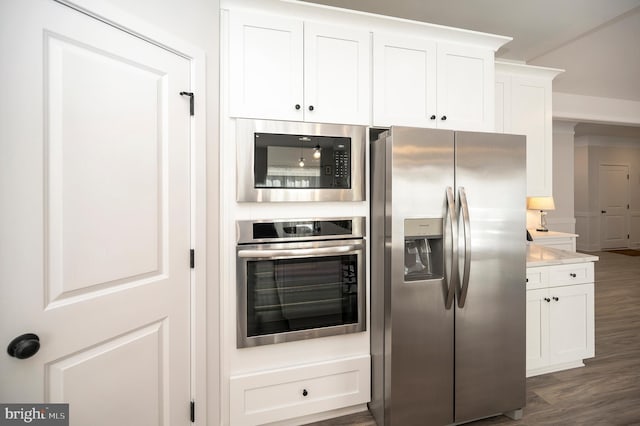 kitchen with stainless steel appliances, dark hardwood / wood-style floors, and white cabinets