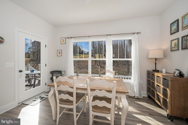 dining space with dark hardwood / wood-style floors