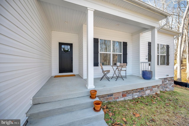 view of exterior entry with covered porch