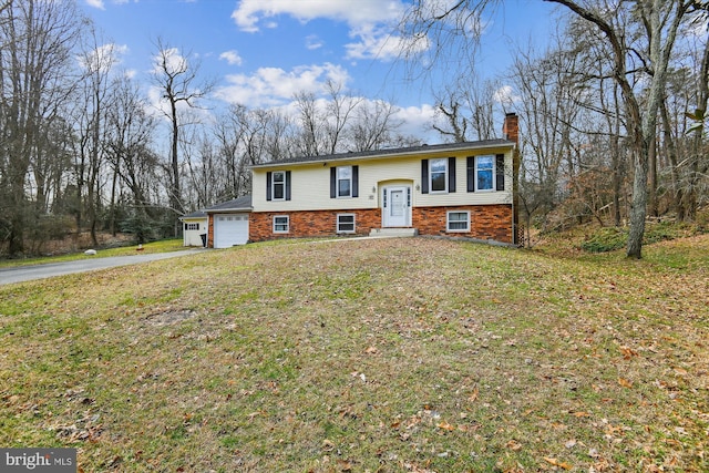 split foyer home with a garage and a front yard