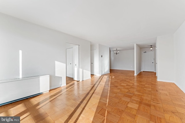 unfurnished room featuring light parquet floors and an inviting chandelier