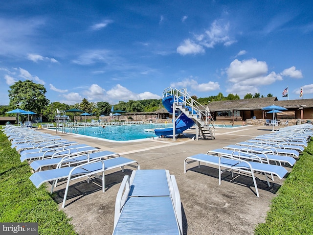 view of pool featuring a playground and a patio