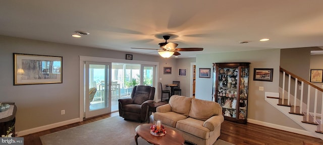 living area with stairs, recessed lighting, wood finished floors, and baseboards